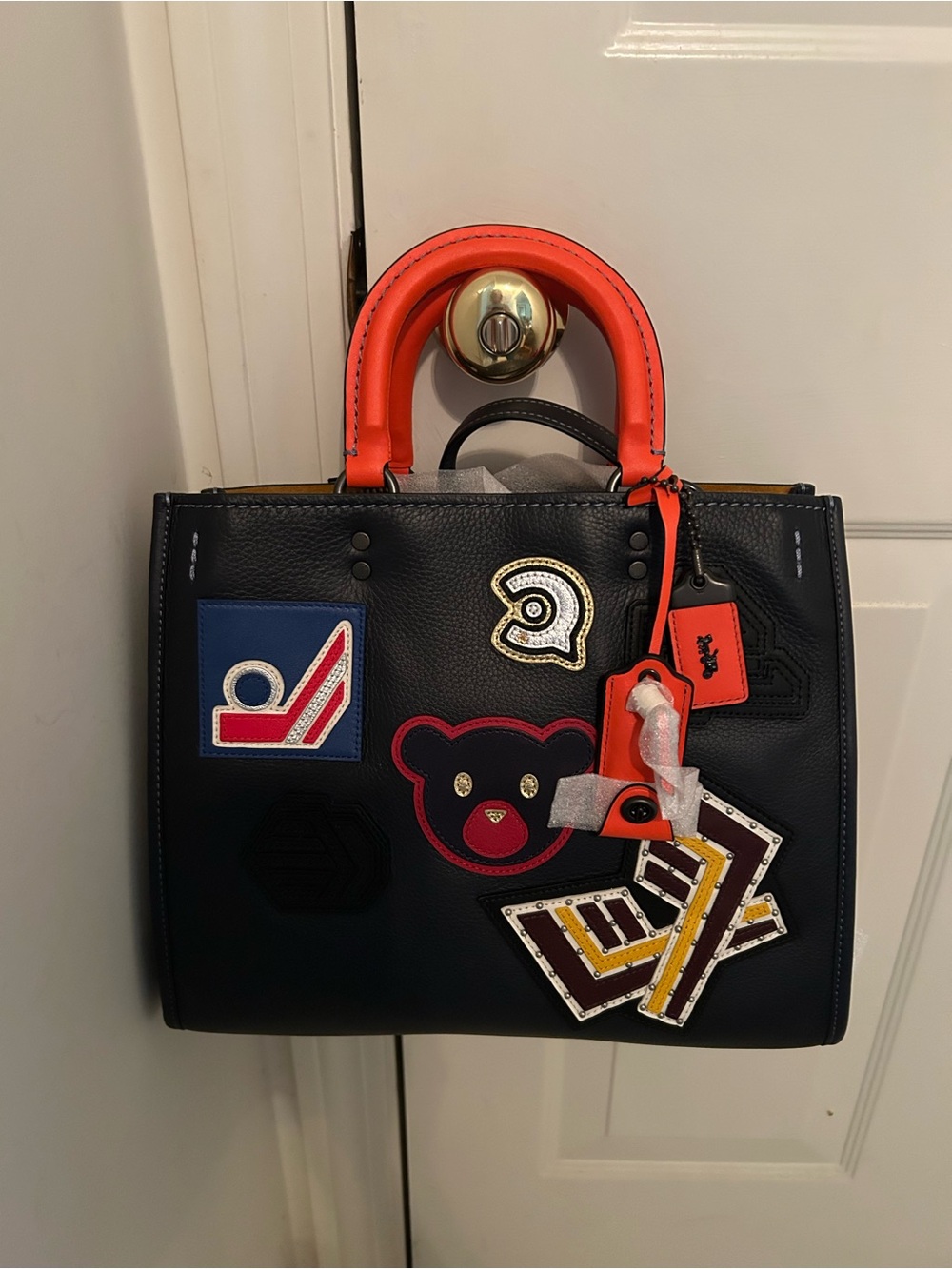Coach Black Leather Patchwork Tote with Orange Handles and Multicolor Patches